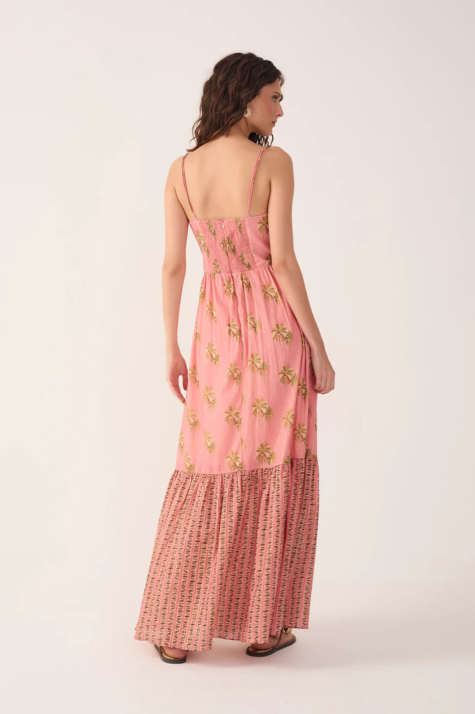 Woman wearing a pink floral dress on a white background