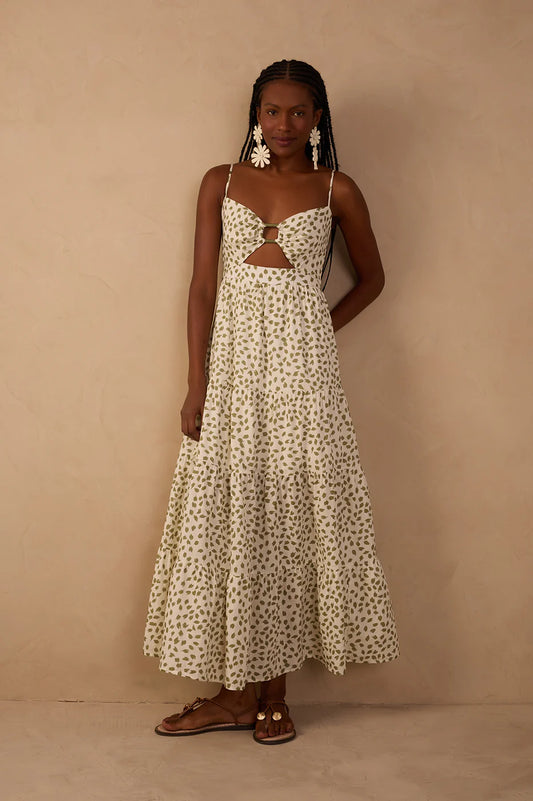 Woman wearing a white floral dress against a beige background