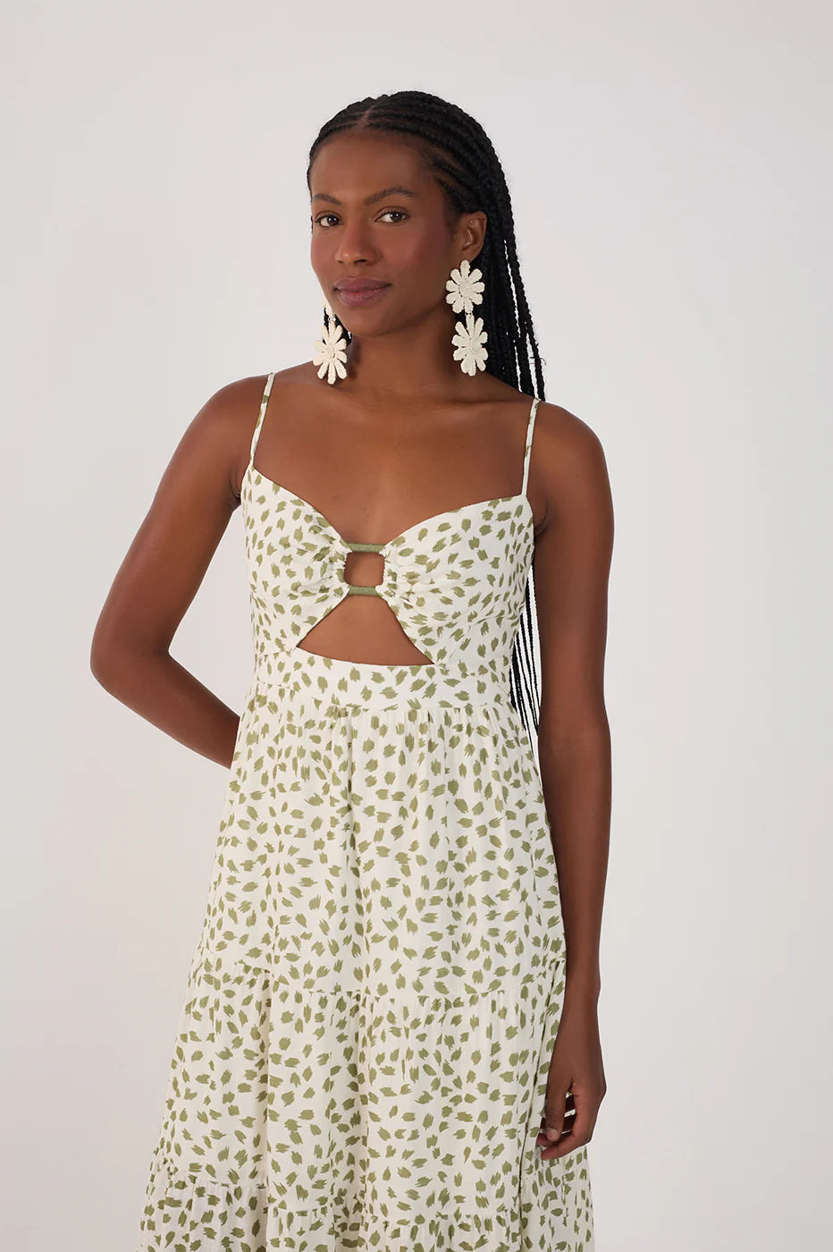 Woman wearing a floral dress with cut-out design on a white background