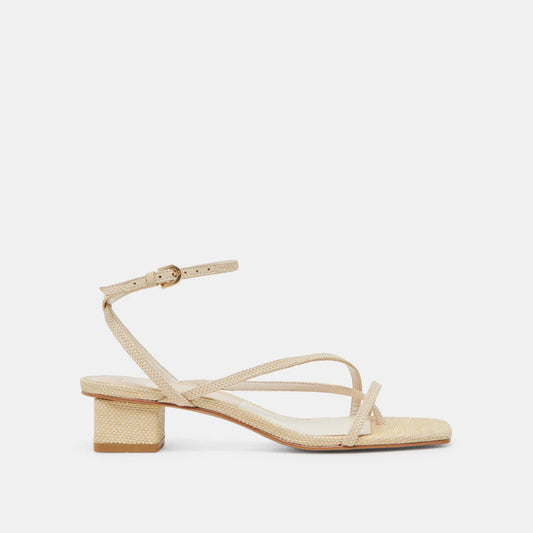 Beige sandal with a block heel on a light beige background