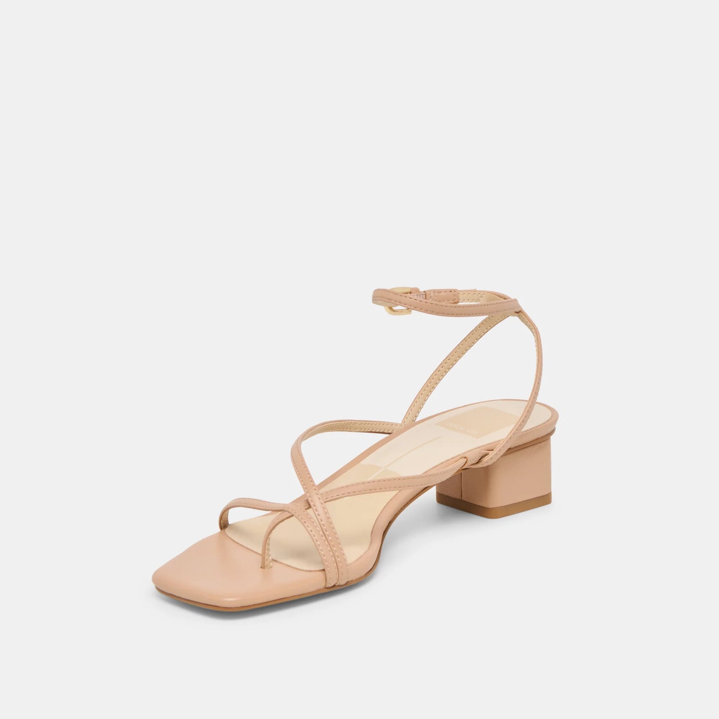 Beige sandal with thin straps on a light gray background