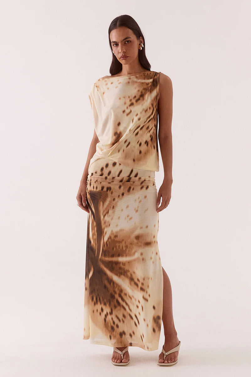 Woman wearing a sleeveless dress with a pattern on a white background