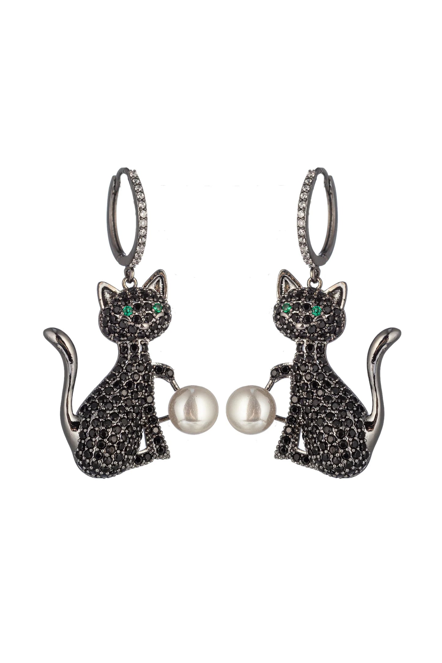 A pair of silver-tone dangle earrings shaped like sitting cats, covered in small black pavé stones, with green eye details and a white pearl held between the cats, on a plain white background.