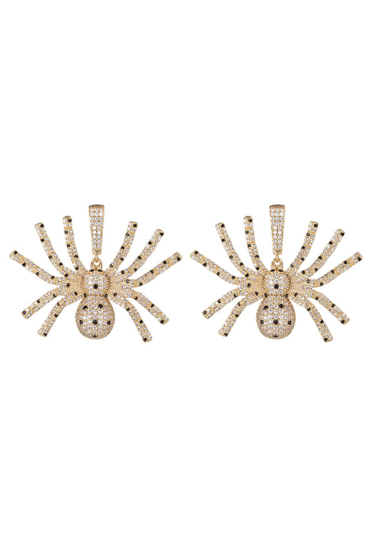 A pair of gold spider-shaped earrings paved with clear crystals, displayed side-by-side against a plain white background.