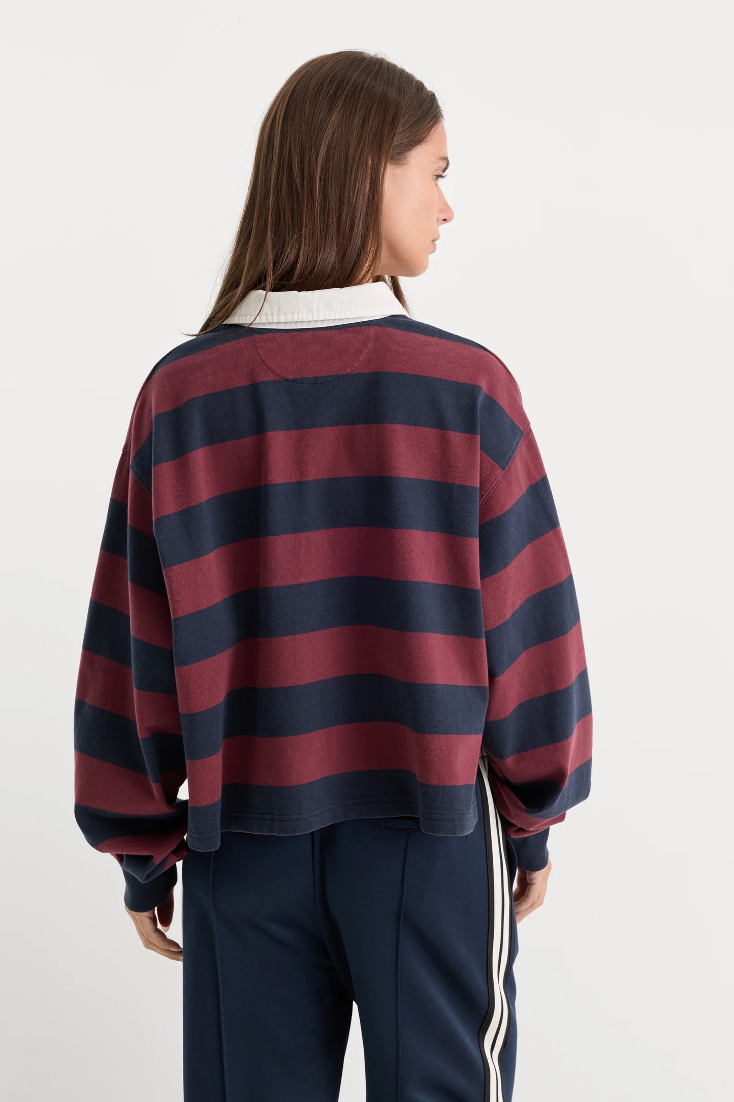 Woman wearing a red and navy striped sweater on a white background