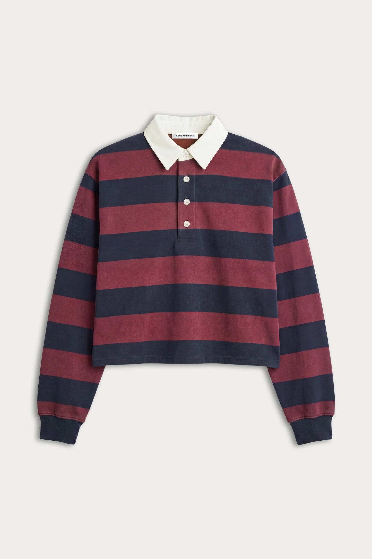 A cropped long-sleeve rugby-style polo shirt with horizontal navy and burgundy stripes, a white collar, and a three-button placket, shown on a light gray background.