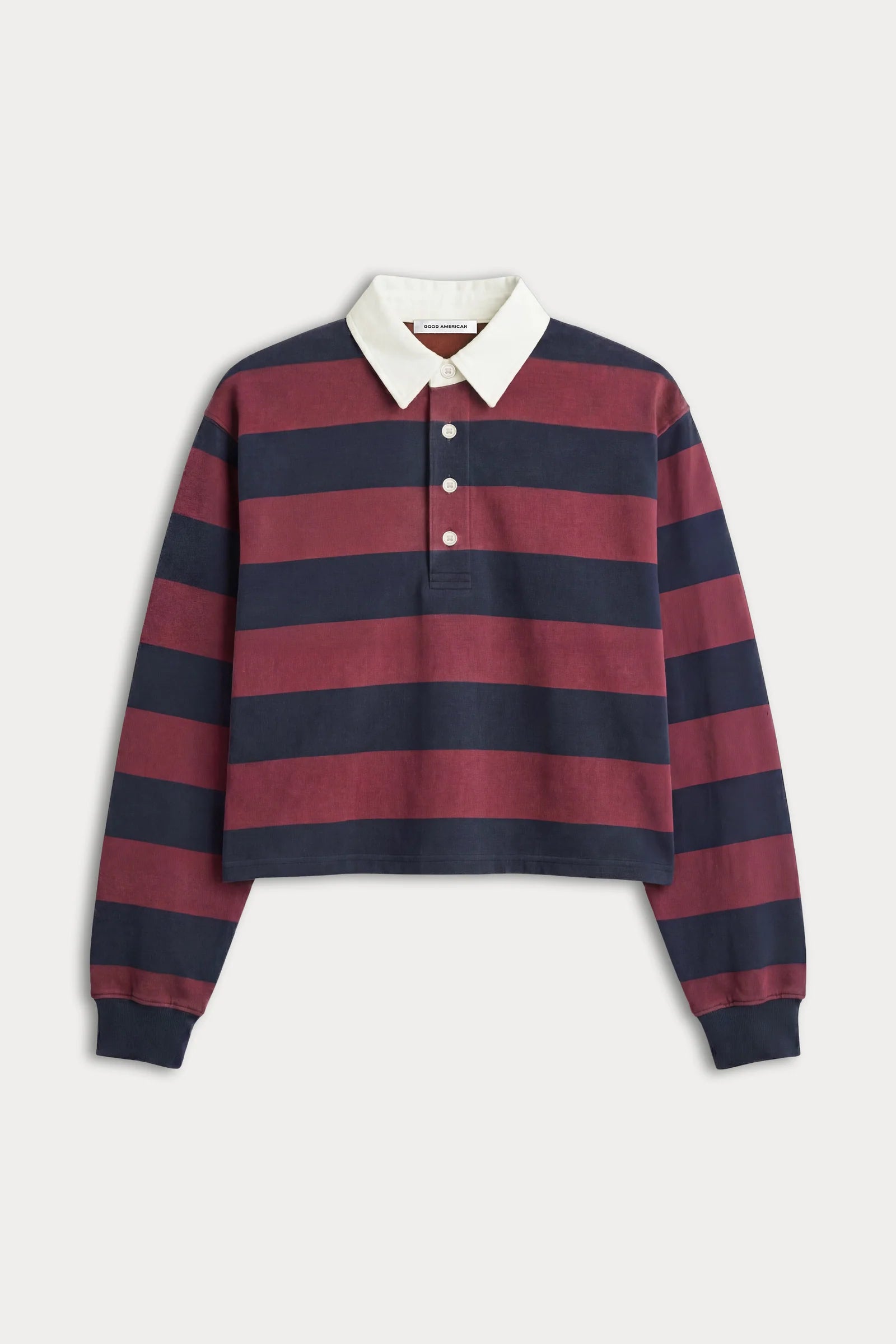 A cropped long-sleeve rugby-style polo shirt with horizontal navy and burgundy stripes, a white collar, and a three-button placket, shown on a light gray background.