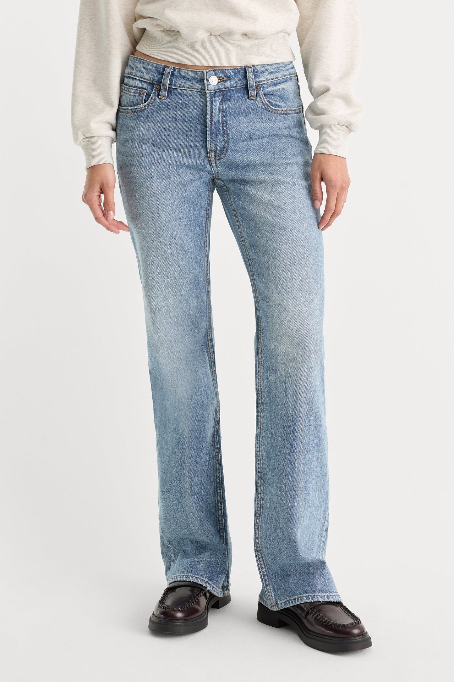 Light blue jeans worn by a person on a white background