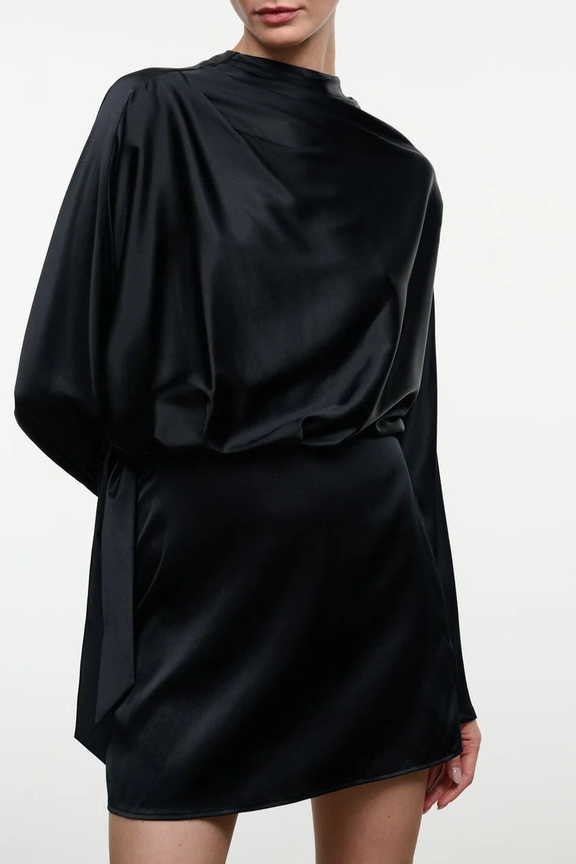 Model wearing the STAUD Phoebe silk mini dress that features a high neck and long sleeves on a neutral background.