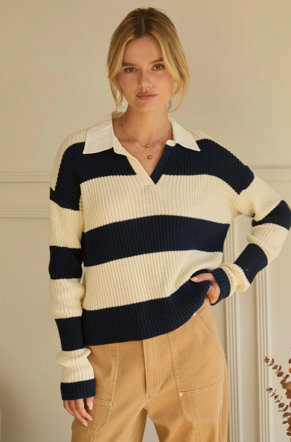 Woman wearing a striped sweater with a plain background