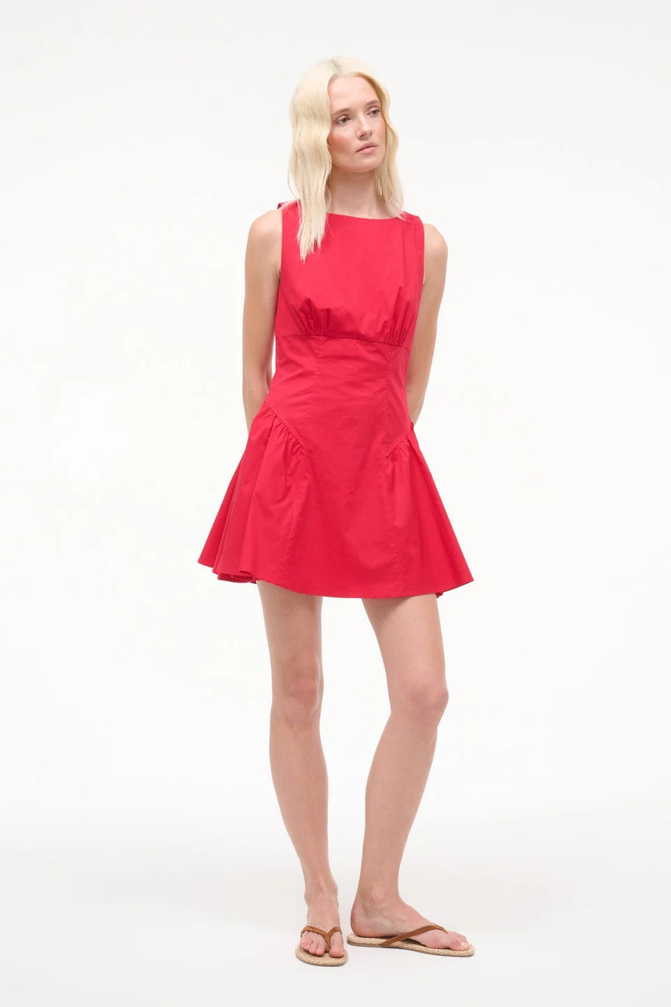Woman wearing a red dress on a white background