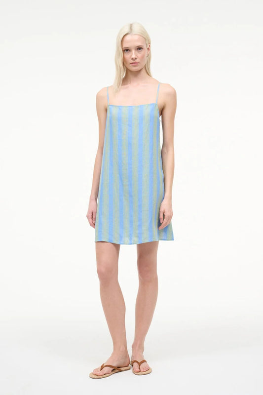 Woman wearing a light blue striped dress on a white background