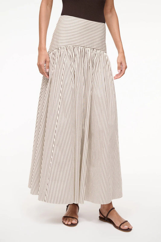 Woman wearing a long striped skirt on a white background