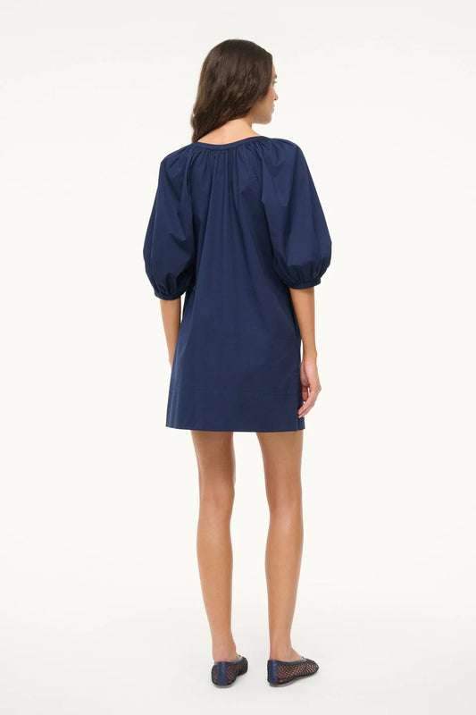 Woman wearing a blue dress on a white background