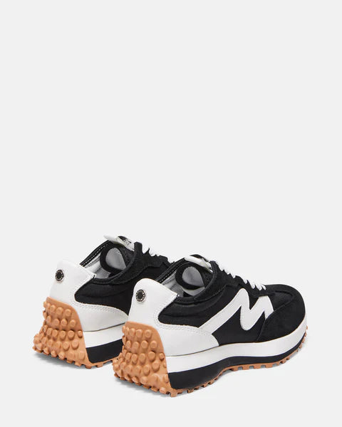 Steve Madden Campo thick soled Sneaker in Black and white With a brown tread from the back view