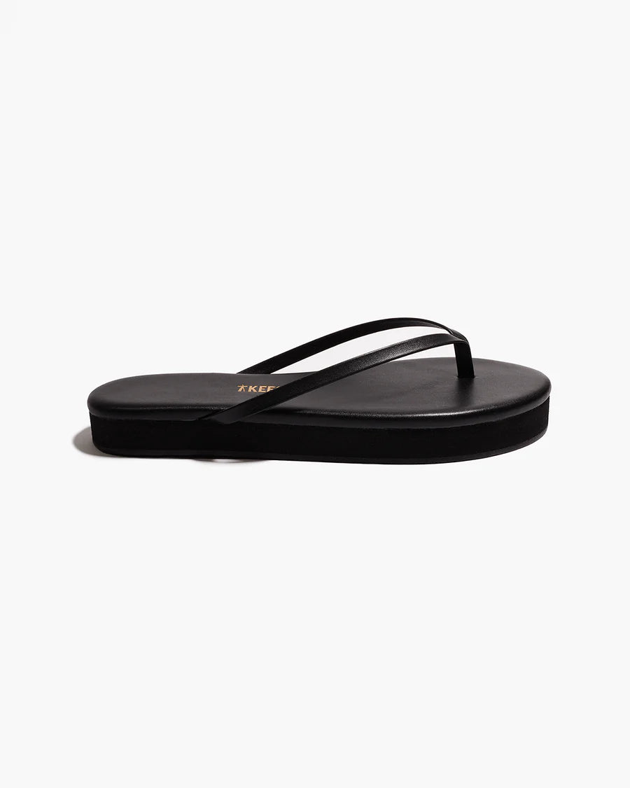 Tkees black platform flip flops on a white background