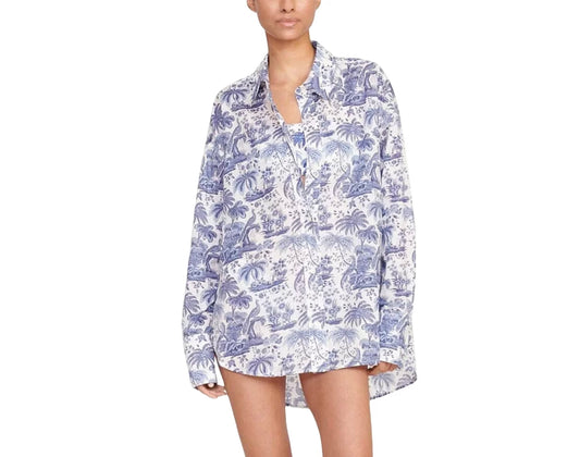 Woman wearing a blue and white patterned shirt on a white background